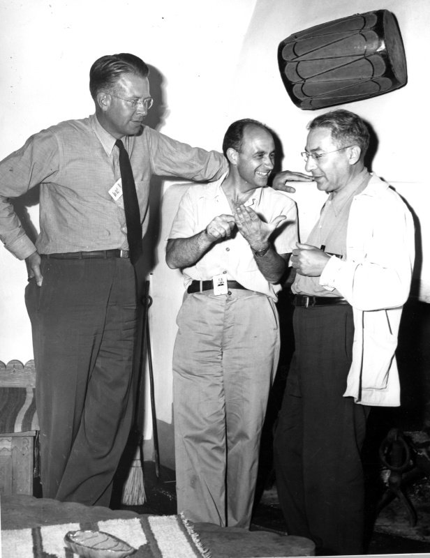 Ernest O. Lawrence, Enrico Fermi at center, and Isidor I. Rabi standing together at Los Alamos in 1945.
