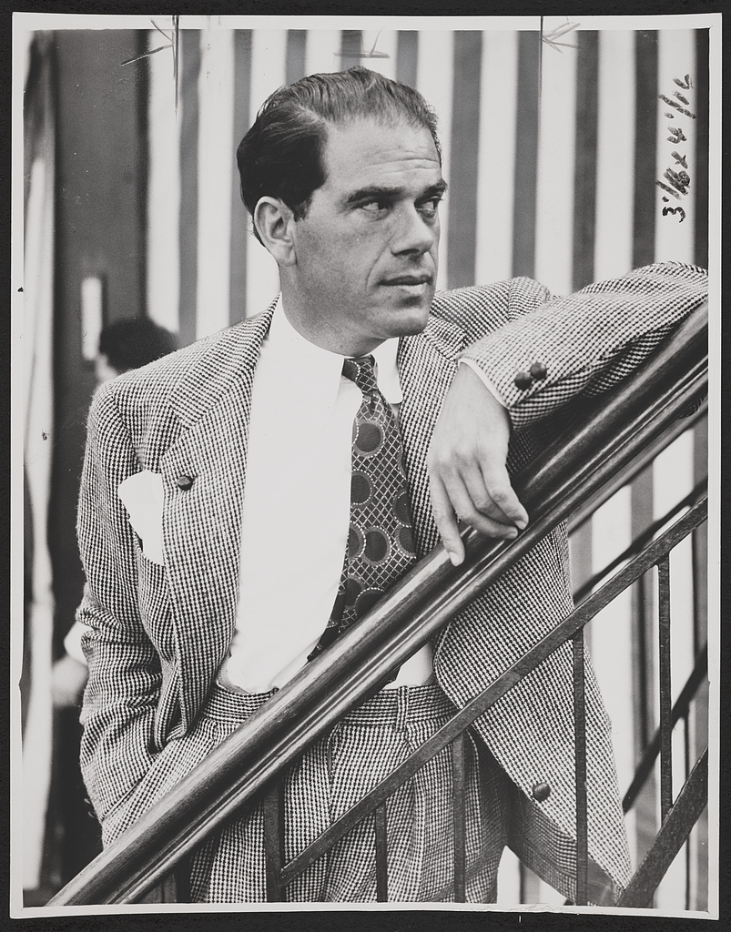 Frank Capra in a checked suit, resting his arm on a railing aboard the Rex, 1937.